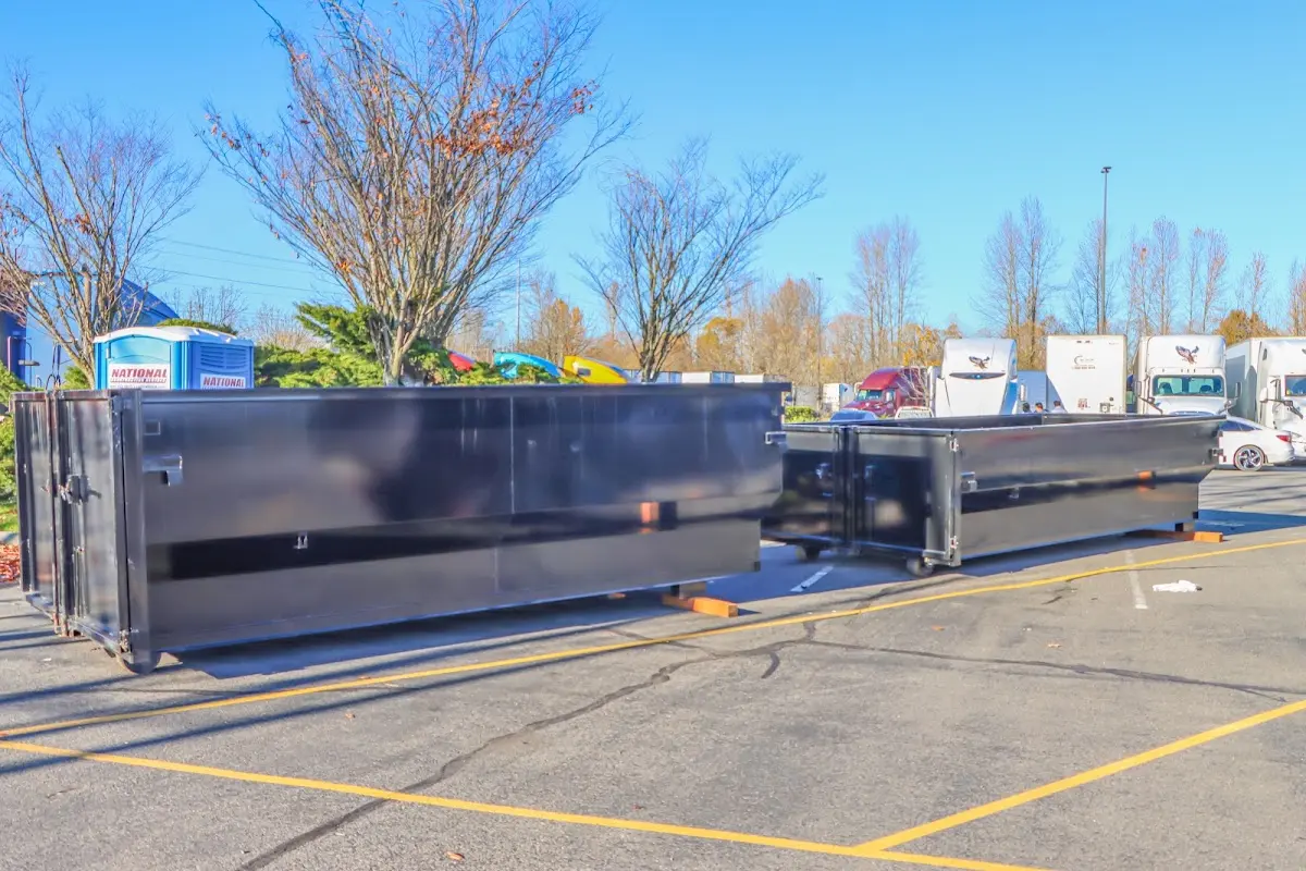 Professional dumpster rental service with roll-off container on residential driveway in Clay